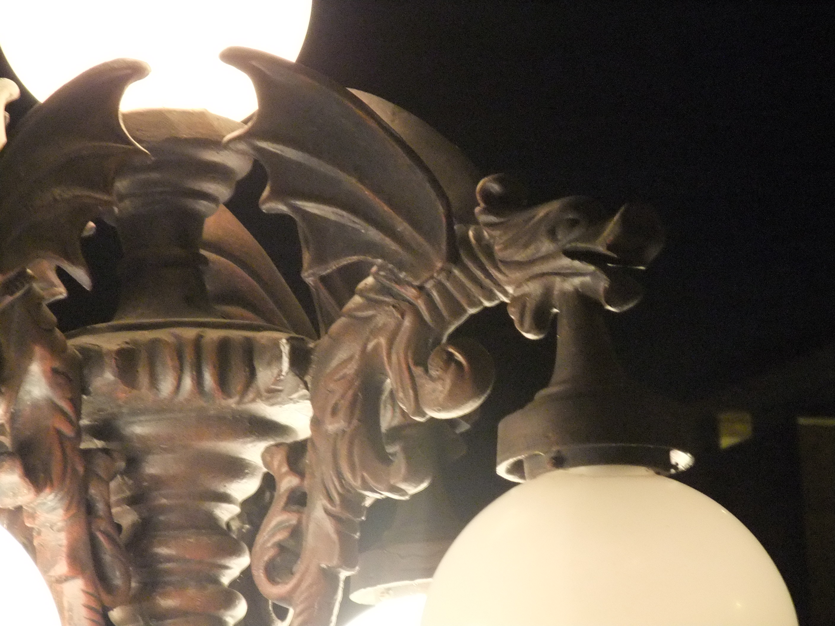 A gargoyle lamp lit up at night at The Edge of Hell haunted house in Kansas City