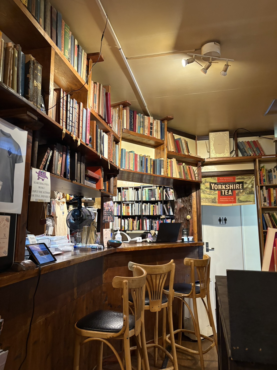 Inside Infinity Books — the bar counter and shelves