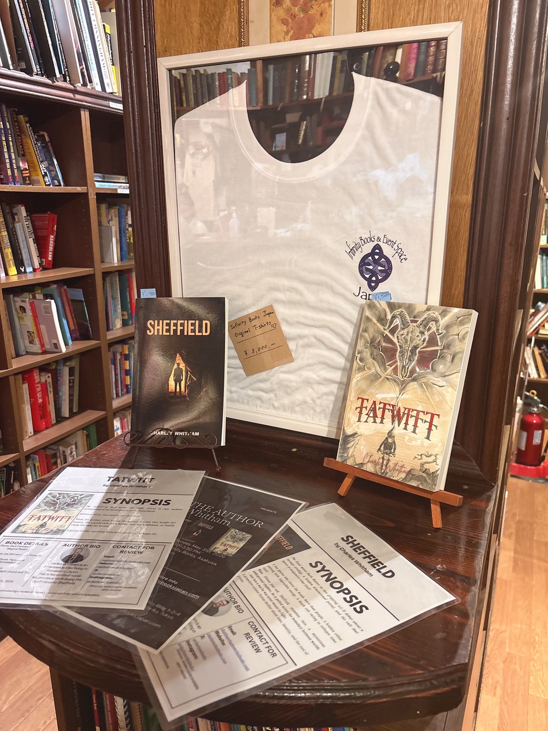 Infinity Books display table with Sheffield and Tatwitt on easels